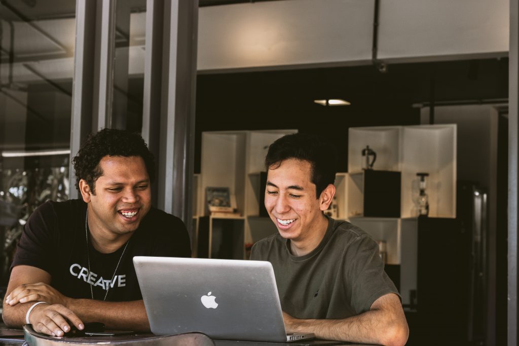 Two people working and smiling