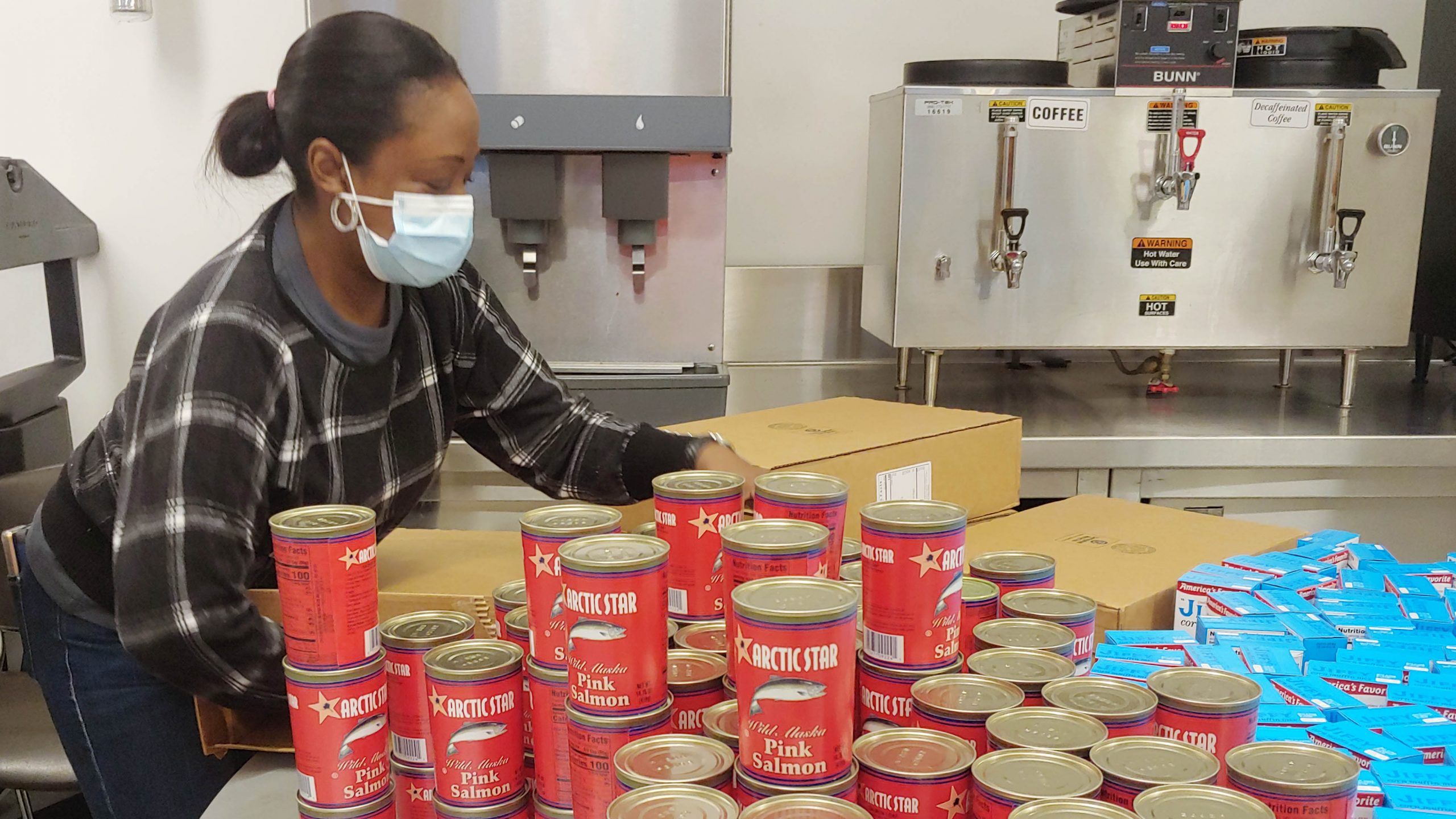 GMHC volunteer preparing food packages for clients.