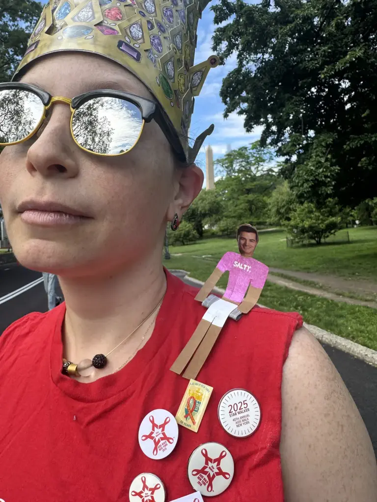 Salty Bitch royalty Deanna Wallach sports a tiny effigy of fellow Salty Bitch Vince Gatton in absentia.