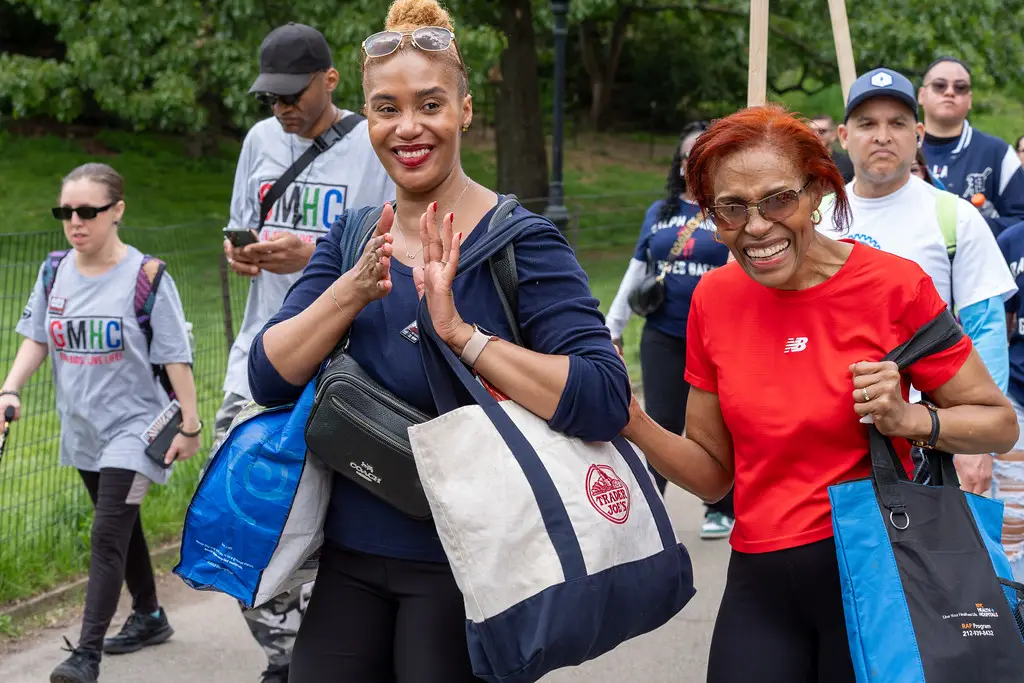 Young and older women in red T-shirt walking.